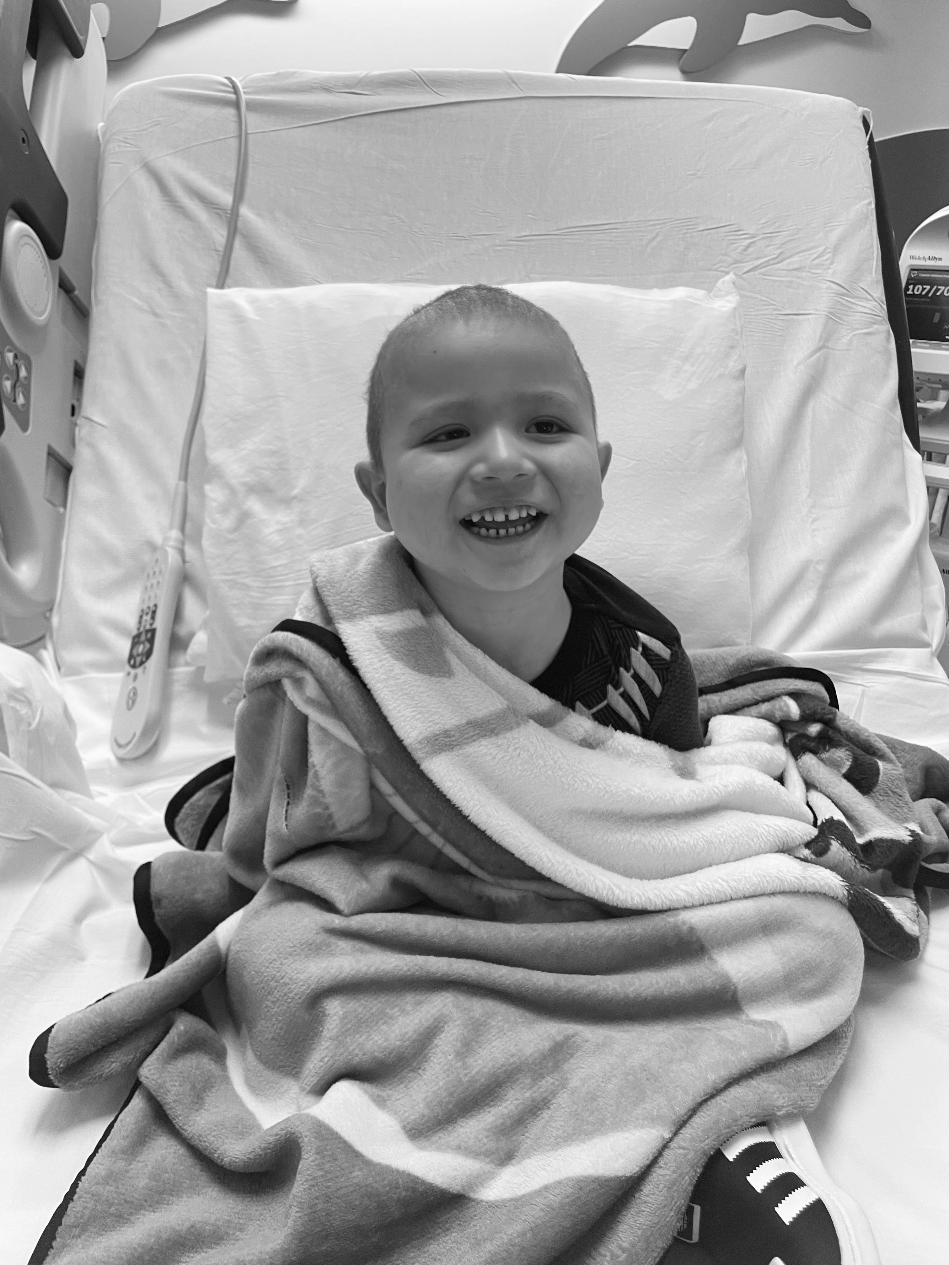 Max smiling in hospital bed