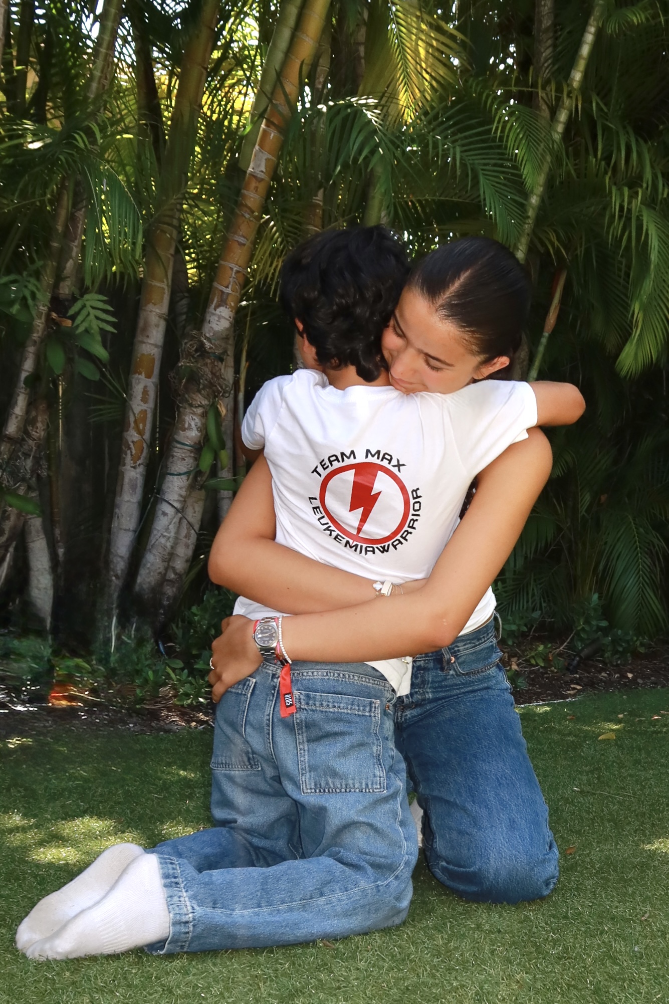 Clementina hugging Max in Team Max shirts